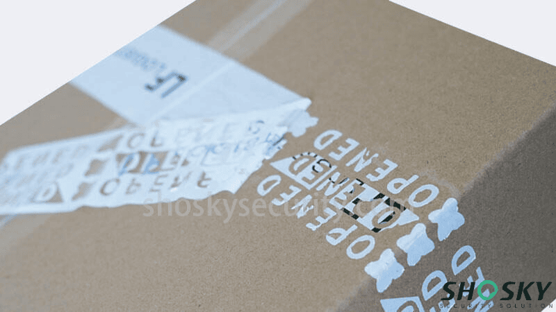 A cardboard box with tamper-evident carton sealing tape peeled back to reveal a bold "OPENED" security message on the surface.