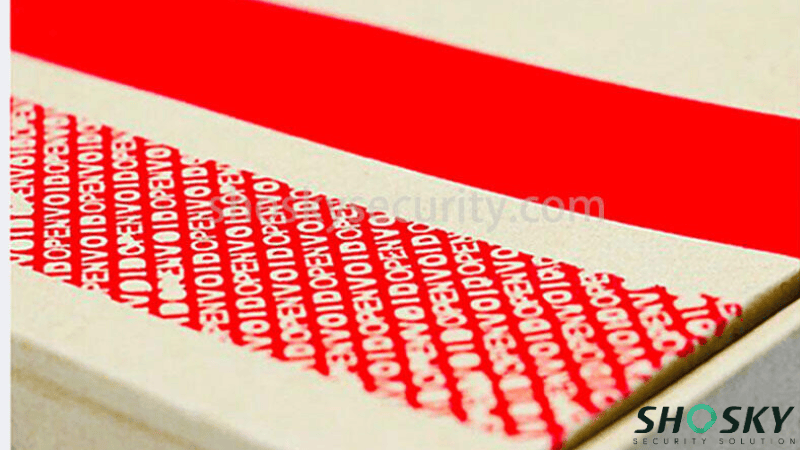 Red tamper-evident carton sealing tape applied to a package, showing both intact red tape and peeled residue with "VOID OPEN" text.