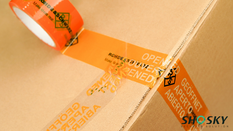 an orange custom tamper evident tape using on a box packaging