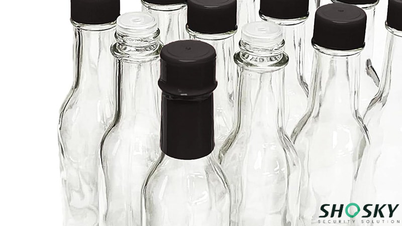 Glass hot sauce bottle with shrinking tamper proof packaging