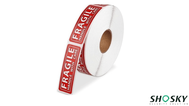 a roll of red standard label with "Fragile" word sign