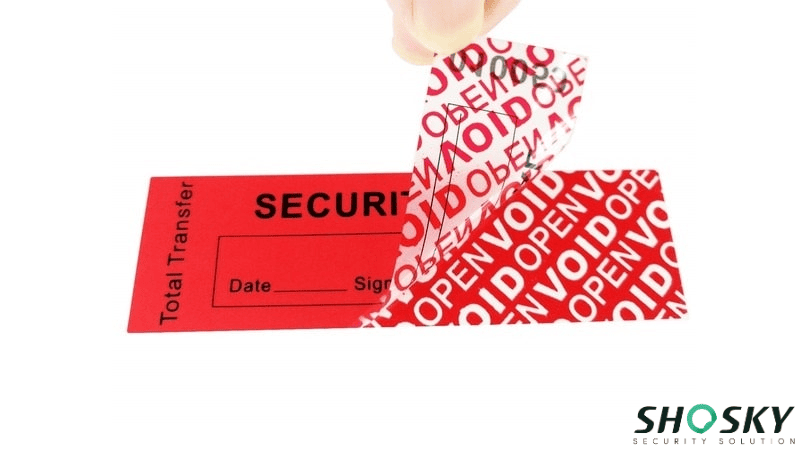 Red tamper-evident security label being peeled off