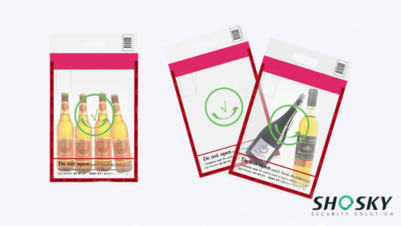 Red-bordered duty-free bags with bottle and green card