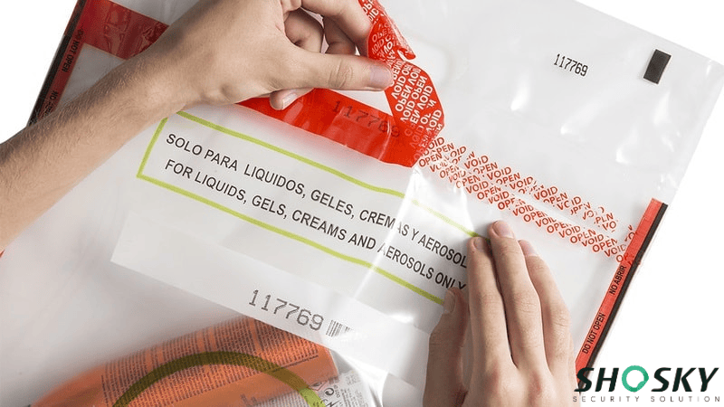 White duty free tamper-evident bag with red border with duty-free purchases