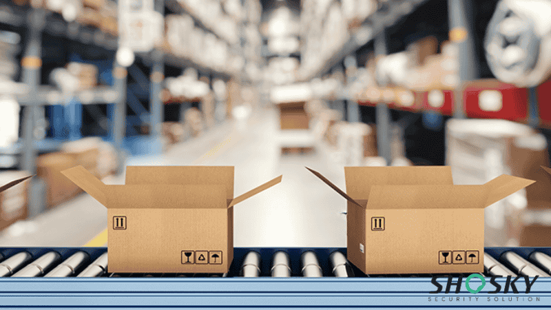 Open cardboard boxes on a conveyor belt in a warehouse, showing packaging workflow integration
