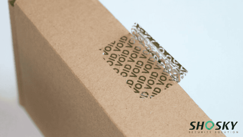 Close-up of red security tape on a box, indicating signs of tampering