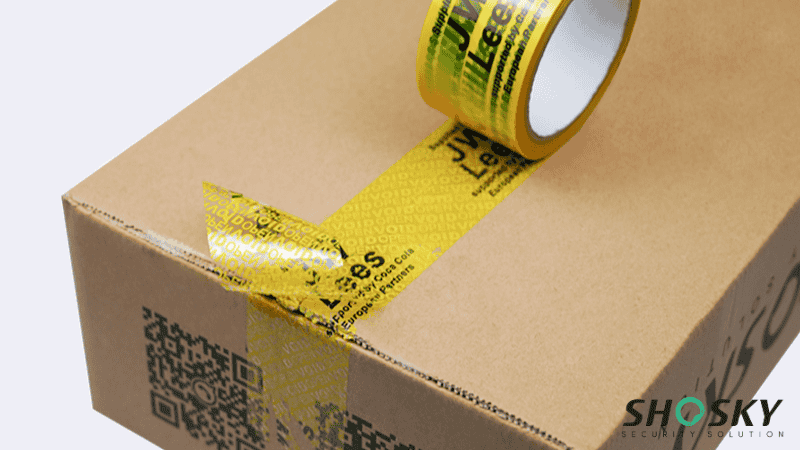 yellow tamper evident tape using on a cardboard box packaging