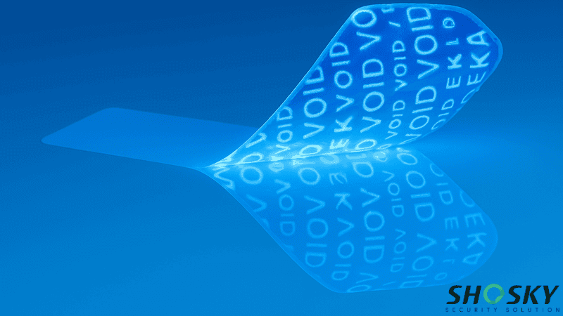 Partially peeled tamper-evident adhesive label showing "VOID" markings