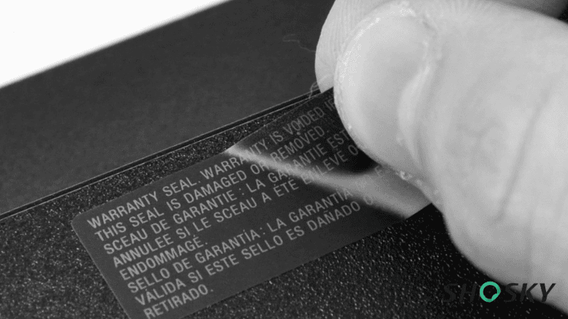 Close-up of warranty void label protecting critical components in heavy equipment