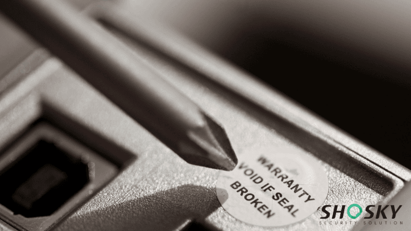 Close-up of tamper-evident label protecting electronic control units in machinery
