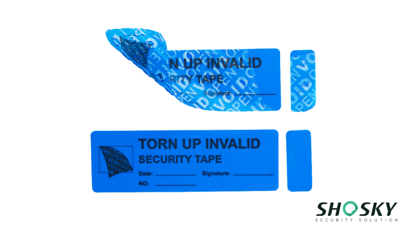 a blue security label, showing irreversible damage when removed