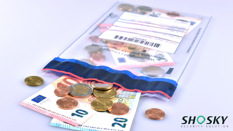 Tamper-evident cash bag labeled for tracking, containing coins and bills