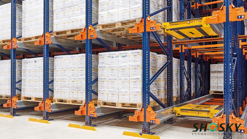 Warehouse shelves labeled and stacked with boxed goods for traceable operations