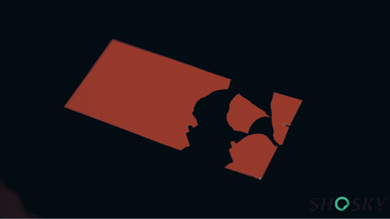 Fragile red destructible security tape shattered into pieces on a black surface