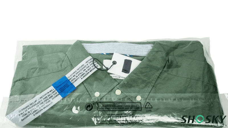 Green collared shirt with security tag, packaged in clear tamper-evident bag