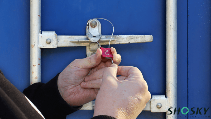 A Man is Applying a Shosky's Heavy Duty Cable Seal for Tanker Valves