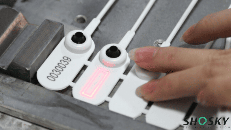 Laser is marking the serial number on the white plastic safety seal