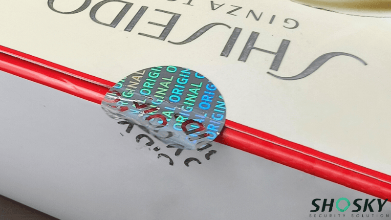 Hologram security label with VOID feature on luxury packaging for brand authentication and tamper detection