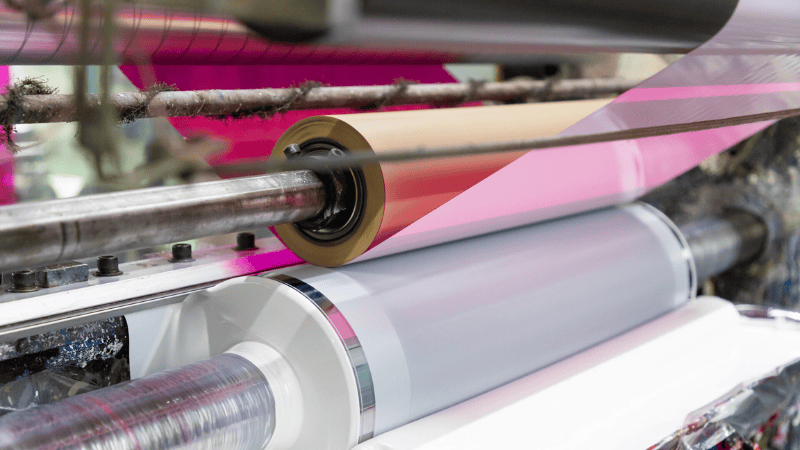 Industrial rotary press applying specialized security printing techniques for tamper-evident labels and high-security packaging