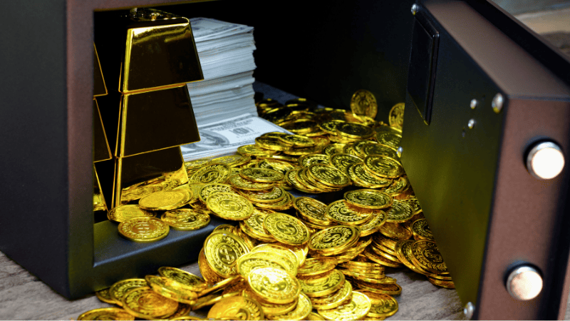 Gold bars and coins are kept in a safe for security.