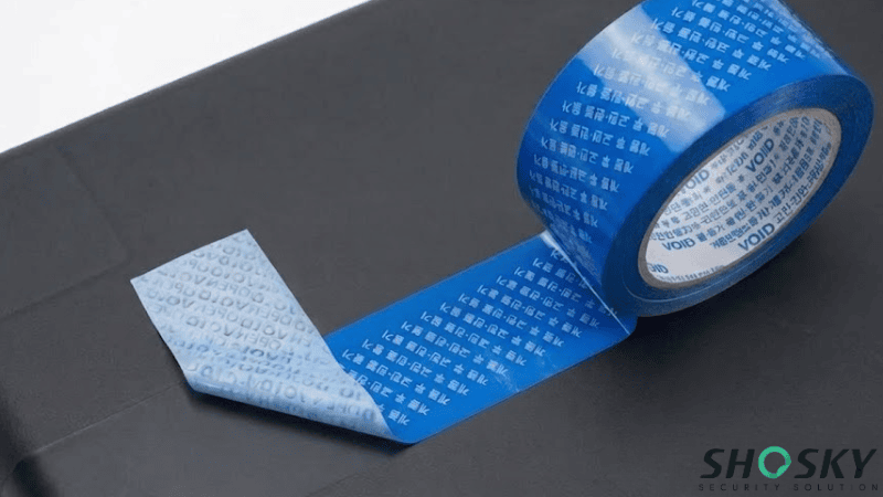 Blue non-transfer tamper-evident VOID security tape with Korean text showing residue upon removal.