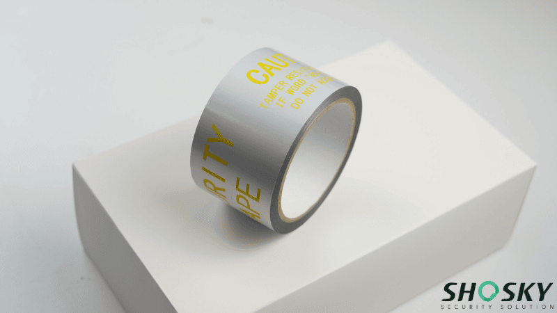Silver silver tamper-evident security tape on a white box