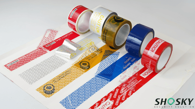 Multiple rolls of custom Extreme Temperature Security Tape in different colors, showing hidden tamper-evident messages