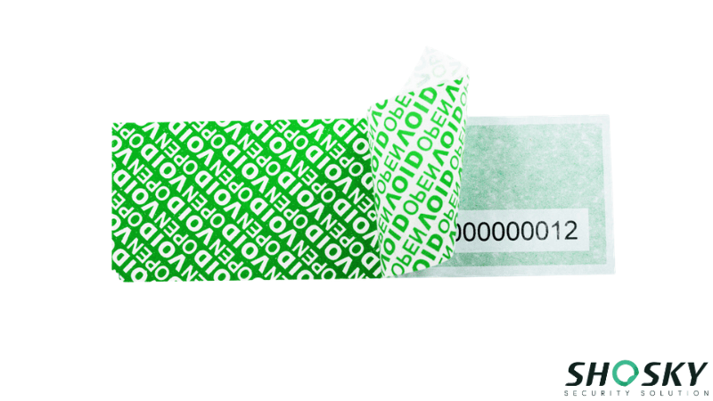 a green paper tamper evident material being peeled and leaving behind "VOID" security message