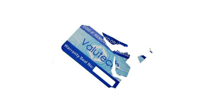 A blue ultra destructible label printed with "Valutech Warranty Seal No:" that tears and breaks into small pieces upon removal to prevent tampering.