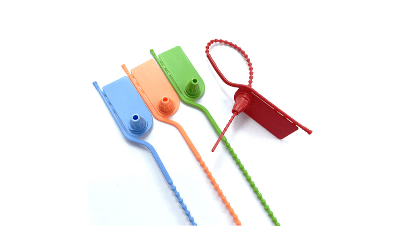 A set of colorful pull-tight plastic seals in blue, orange, green, and red with beaded tail straps and locking tags.