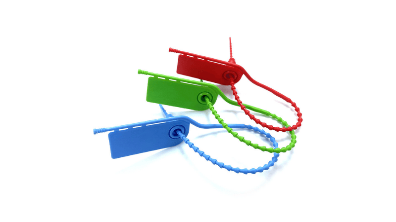 Three pull-tight plastic seals in red, green, and blue, each looped and secured with a beaded strap and identification tag.