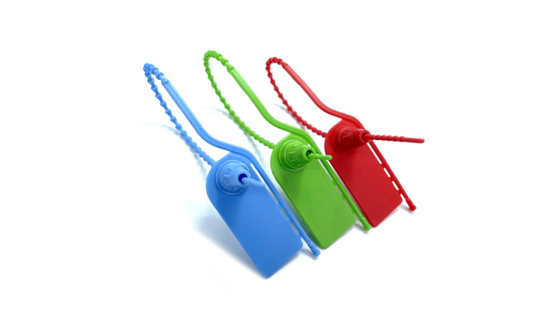 A row of three pull-tight plastic seals in blue, green, and red showing their locking mechanisms and beaded tail straps.