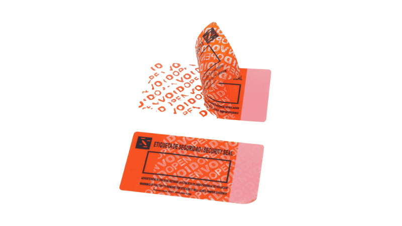An orange tamper proof sticker peeled back to reveal a "VOID OPEN" residue pattern left behind on the surface, demonstrating its security evidence effect.
