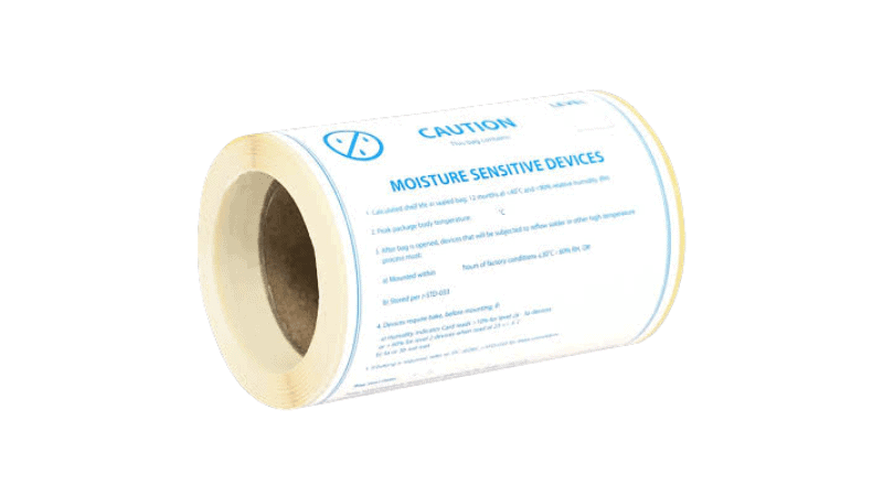 A roll of water sensitive indicator labels printed with "MOISTURE SENSITIVE DEVICES" caution text and handling instructions
