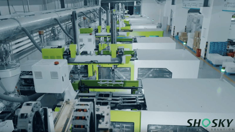 An overhead view of a modern automated injection molding production line in the Shosky manufacturing facility for security seals.