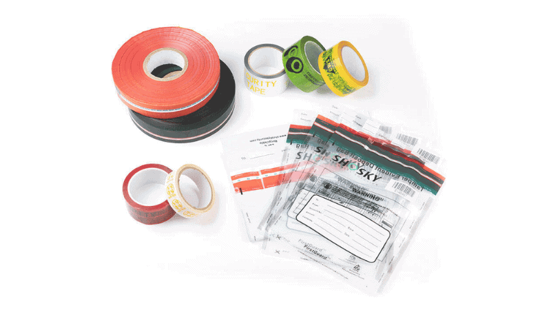 Assorted tamper-evident security packaging materials including colorful printed security tapes, void tape rolls, and transparent tamper-evident deposit bags