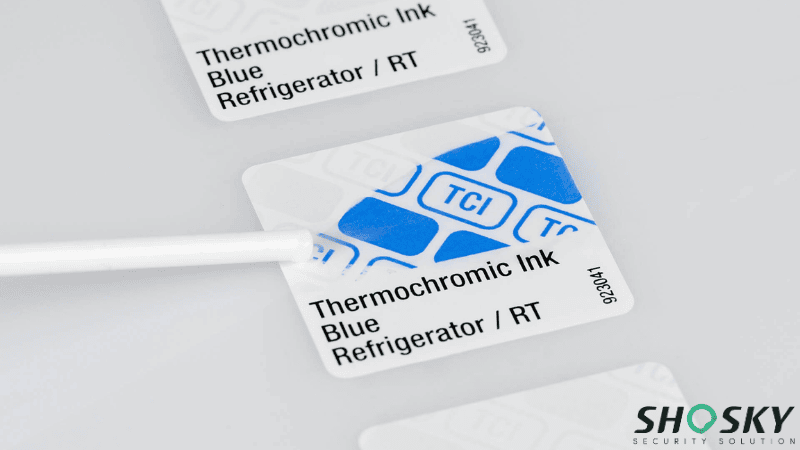 Blue thermochromic ink security label being tested with a swab to demonstrate temperature-sensitive color-changing properties.